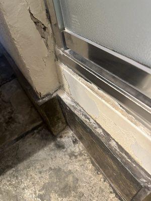 Outside of shower has cracks and gouges in sheet rock