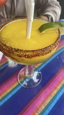 Bomb mango frozen margarita with chamoy y chile tajin rim