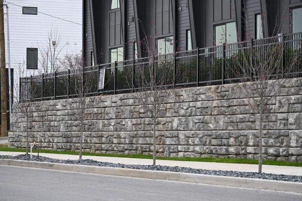 Redi-Rock Retaining Wall 7.5 foot tall with aluminum safety railing.