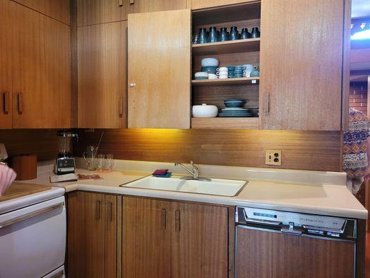 Kitchen cabinets have piano hinges, so they fold all the way back.