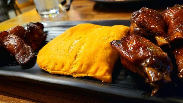 Jamaican beef patty, mango jerk chicken wings, and fried plantains