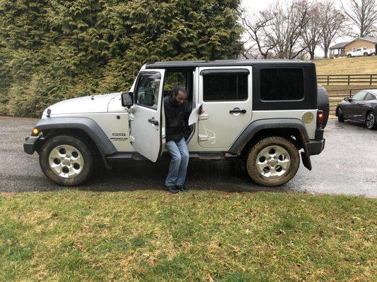 Joe the salesman getting out of the Jeep