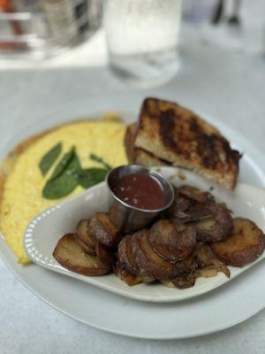 Crawfish omelette and side of potatoes