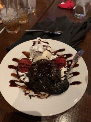 Molten lava cake with ice cream, strawberries and whip cream