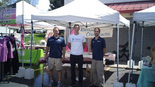 Dr Kambeitz, Troy the personal trainer, and Thomas the massage therapist at the KCHWC booth at a local 5k