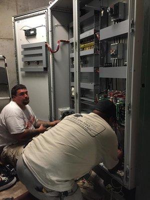 Commercial Electrical Services - Technicians Adjusting Electrical Systems