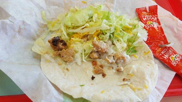 Usually when you order a chicken soft taco it comes with chicken inside. They must be in a chicken recession here.