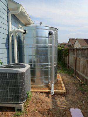 Rainwater collection system used for irrigation purposes with 1,500 gallon galvanized metal cistern