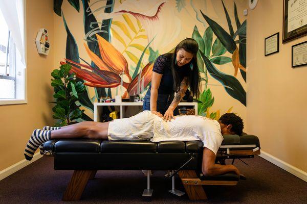 Dr. Mandy assessing the motion of the lower back and pelvis