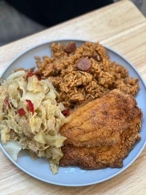 Cabbage, fried catfish and jambalaya rice with sausage.