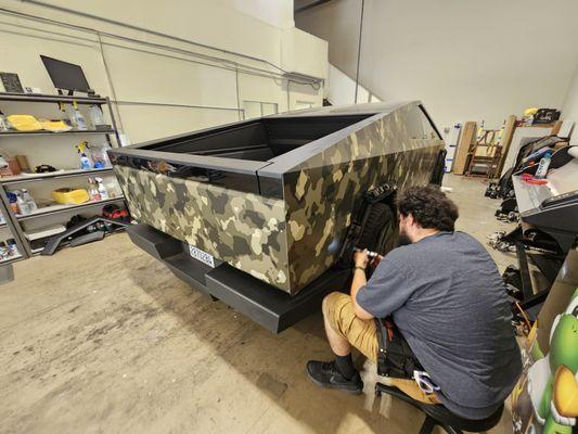 Working on a Tesla Cybertruck with a custom camo wrap we designed in house.