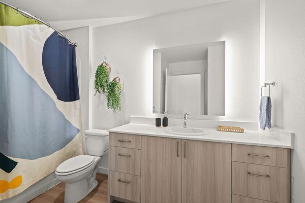 Gorgeous bathroom with quartz countertops, modern vanity, and soaking tub