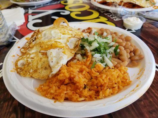 Red chilaquiles with dos huevos