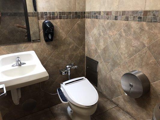 Women's restroom, individual stalls include sink, heated toilet seats with wash and bidet.