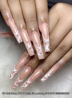 Chic long coffin-shaped nails adorned with a delicate white winding line, creating a stylish and minimalist look