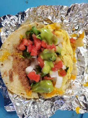 Breakfast pirata dressed with requested salsa bar toppings (green sauce, cilantro, lime, pico de gallo)