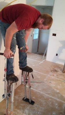 Plasterers on stilts, ready to get those vaulted ceilings.