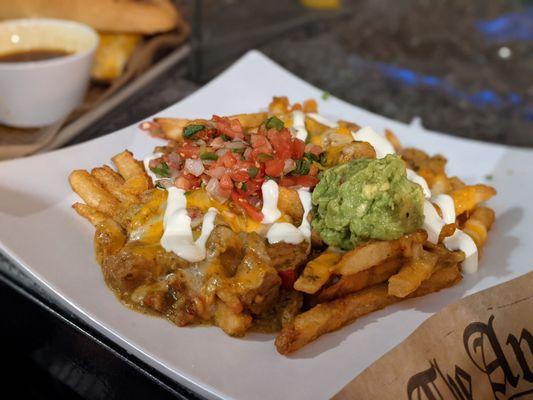 Shredded pork chile verde fries served with guacamole, sour cream and pico.