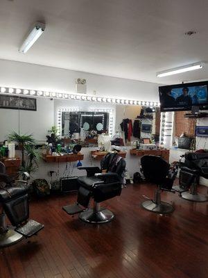 Vanity light bars surrounding mirrors in a local barber shop.