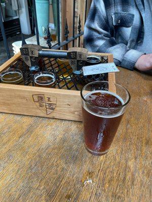 Flight of beers and a pint of the Mt. High Amber Lager.