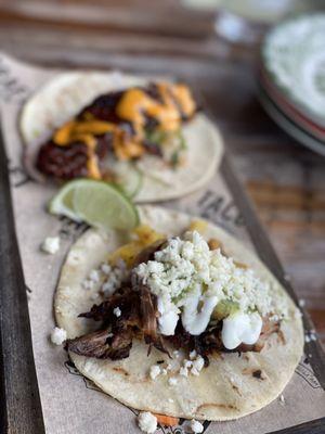 Crispy pork taco (front) and pork belly taco.