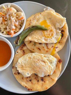 Incredible beans/cheese/carnitas pupusas with fried eggs on top (I cooked the eggs at home). The pepper is SPICY!