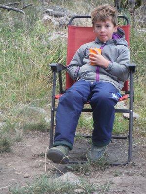 Ari staying warm and cozy in the Norris Pants, Middle Fork Salmon River