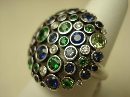 Sapphire, tsavorite and diamond ring set in white gold.