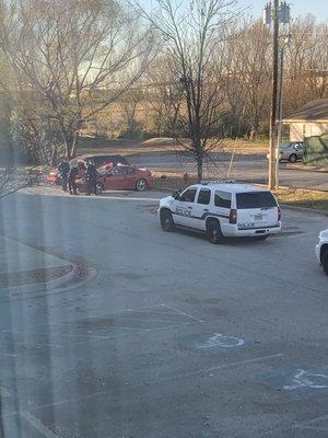 Police doing a drug bust on this guys car in the parking lot