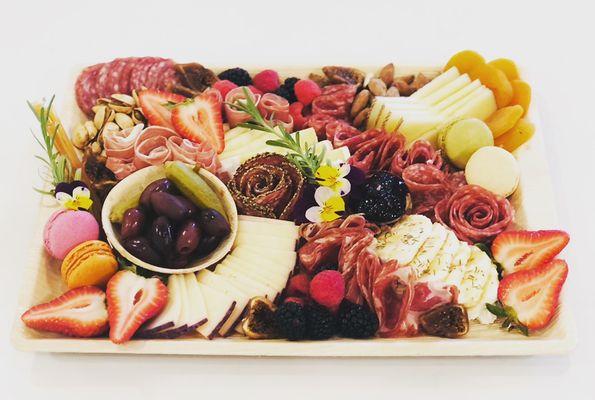 Medium charcuterie board featuring 4 meats, 4 cheese and accoutrements.