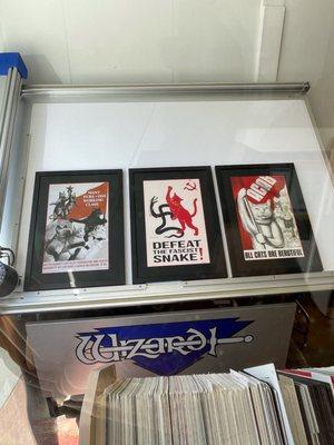 Image of posters framed by the shop. They are cat and Soviet themed posters.