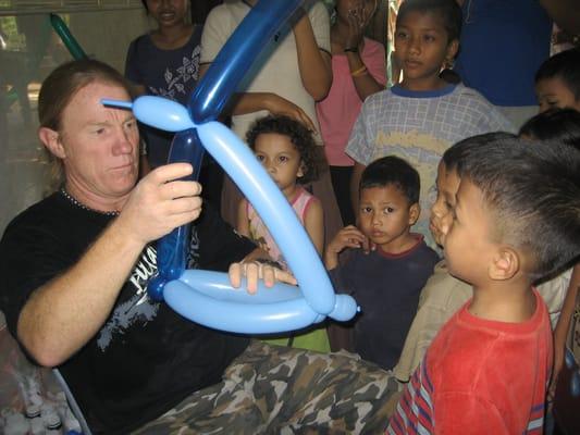 Dr. Johnson making balloon animals after a dental clinic at an orphanage in Cambodia