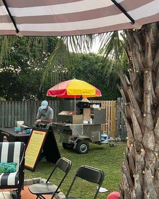 Victor serving up some hot dogs in our backyard.