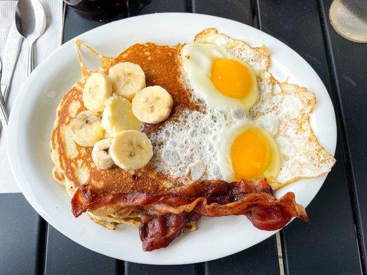 The Combo with Banana Nut pancakes, sunny side up eggs, and bacon!