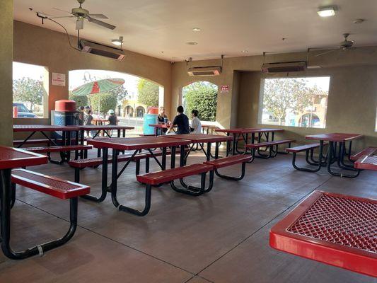 Ample outdoor seating with space heaters above.