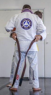 Northshore's head instructor and owner receiving his brown belt