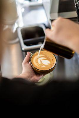 Kennedy making latte art in a personal mug!