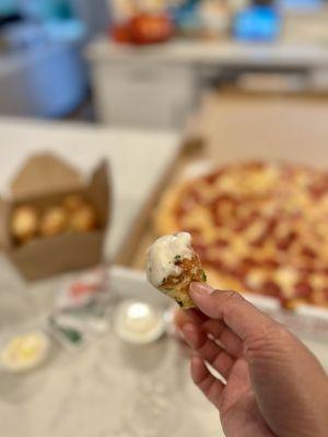 Freshly made garlic knots dipped into Alfredo sauce!