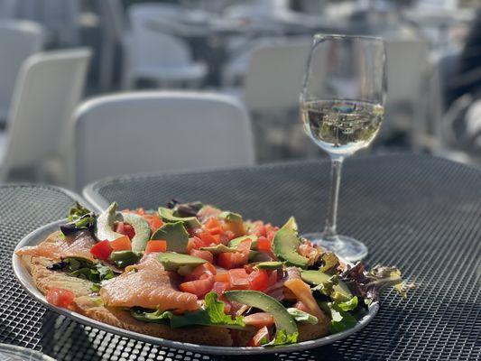 Gluten free bruschetta with salmon, avocado, tomato, and arugula