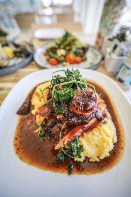 Red Wine Braised Beef Short Rib
Red wine braised beef short rib served over three cheese polenta with baby carrots and green chickpeas.