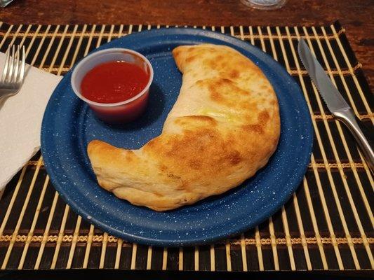 Incredible Calzone! Crispy, pillowy crust, a hint of sweet ricotta and mozzarella that you can pull for yards!