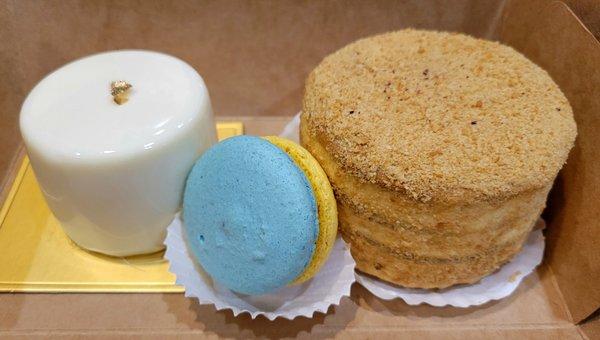 Left: Mini mango passionfruit mousse cake. Right: Mini honey cake. Center: Special edition Ukraine flag colors macaron