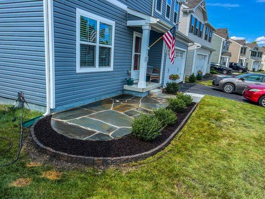 Flagstone patio with landscaping.