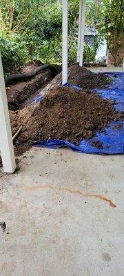 French drain dug along driveway and flowerbed and fence