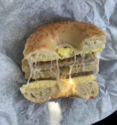 Egg, sausage, and provolone cheese on an Asiago bagel