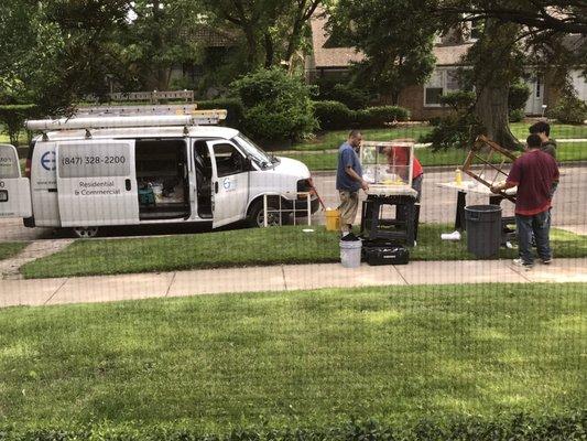 The workers set up shop in front of the house