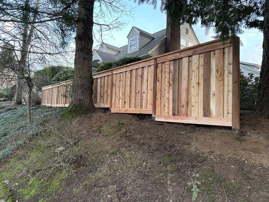 New fence increasing in height to keep the top level across 40'