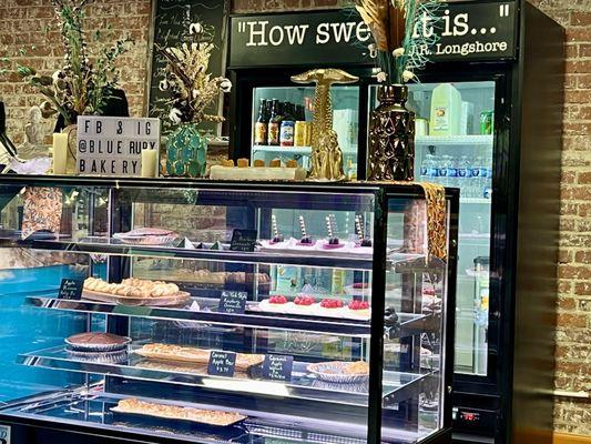 Refrigerated pastry case, right of the register.