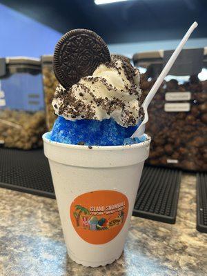 Cookie Monster SNOWBALL Blue coconut flavored stuff with vanilla ice cream topped with whip cream cookie crumbles and Oreo cookie