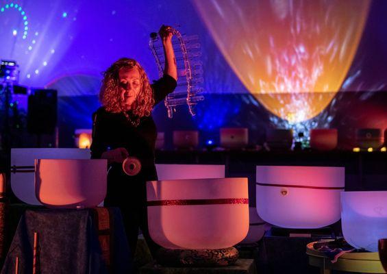 Dr. Gigi Turner playing crystal singing bowls and quartzozphone during a sound bath in Colorado Springs